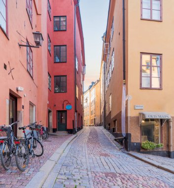 Narrow alley located in Gamla stan, the old town of Stockholm, Sweden with old style colorful houses, parked bicycles, and cobblestone street, Stockholm, Sweden