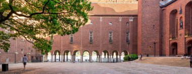 Stockholm, Sweden - June 25 2022: Stockholm City Hall, Stadshuset, on the eastern tip of Kungsholmen island, next to Riddarfjardens northern shore and facing the islands of Riddarholmen and Sodermalm