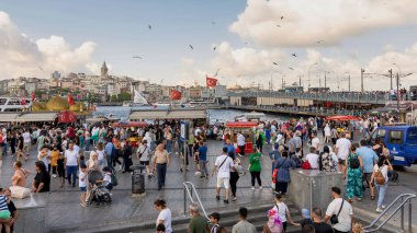 Istanbul, Turkey - August 30, 2022: Crowds of local citizens at Eminonu Piazza during the Victory Day holiday with background of Istanbul city view including Galata Tower