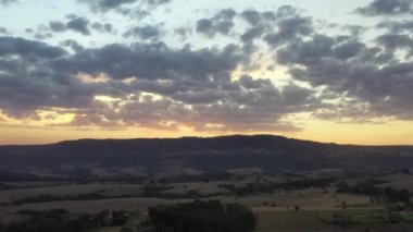 Kırsal kesimde gün batımında çiftçilik manzarası. Yeşil arkaplan ve alan sahnesi.