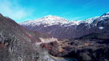 Patagonia road at Ushuaia Argentina province of Tierra del Fuego. Stunning road between nevada mountains and colorful forest trees. Ushuaia Argentina. Patagonia Argentina at Ushuaia Argentina.