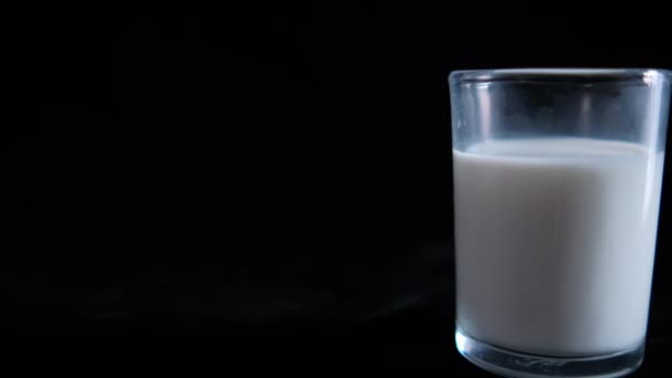 Ditumpuk kue di piring putih dan segelas susu dengan latar belakang hitam — Stok Video