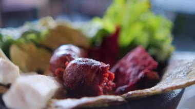 Beyaz peynir dilimleri, marul, sucuk ve Meksika molcajete 'sinde kavrulmuş nopaleler.