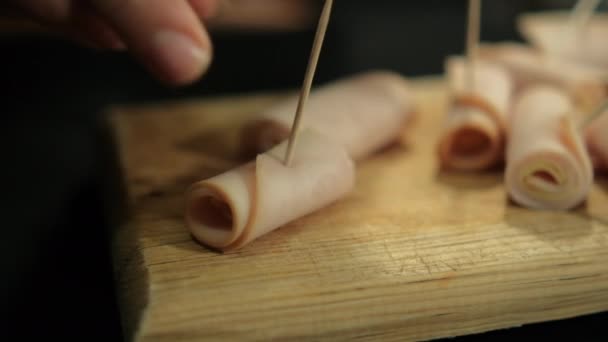 Kalkoenbroodjes met tandenstokers op snijplank — Stockvideo