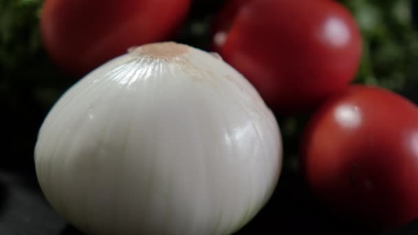 Onion, fresh tomatoes and big lettuce above black background — Stock Video