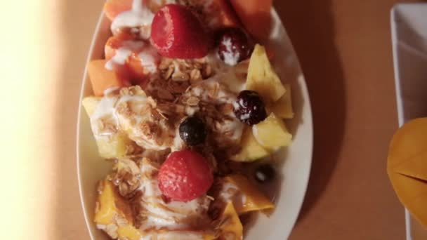 Placa de fruta en rodajas con crema y avena encima — Vídeos de Stock