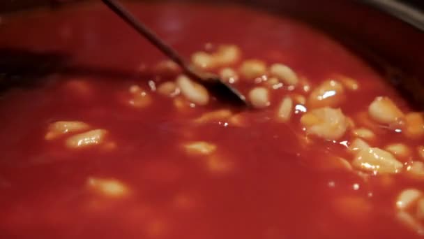 Spoon stirring delicious traditional Mexican pozole in cooking pot — Stock Video