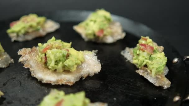 Pork rinds with guacamole on traditional Mexican comal — Stock Video