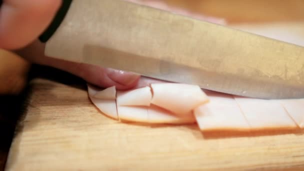 Hands chopping fresh turkey ham slices on a cutting board — Stock Video