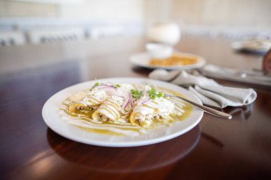 Kahverengi masada yeşil enchilada tabağı.