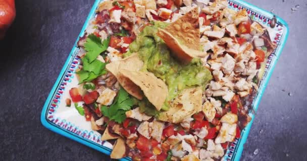 Lahodný talíř nasekaného masa s guacamole na černém povrchu — Stock video