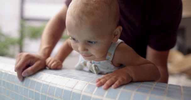 Adorable happy toddler and her father looking over tiled wall — Stock Video
