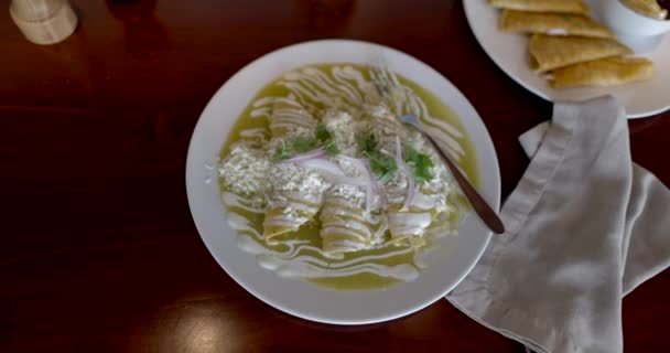 Läckra gröna mexikanska enchilada, och tallrik quesadillas på brunt bord — Stockvideo