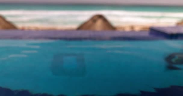 Vacker utsikt över palmparaplyer på stranden med vågigt hav som bakgrund — Stockvideo