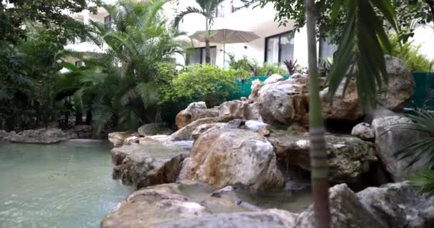 Beautiful rocky cascade and pond behind log railing — Stock Video