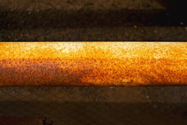 Gas Rusty steel pipe, Steel pipes are placed in the factory, steel pipe for manufacturing. Old yellow pipe on a dark background