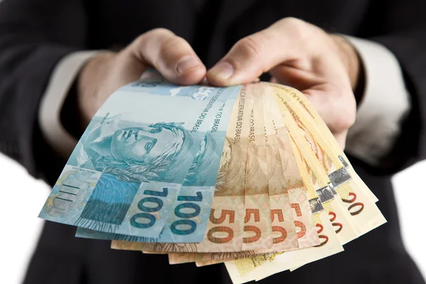 Geschäftsmann zeigt Ihnen brasilianisches Geld. lizenzfreie Stockbilder