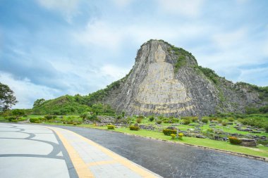 Pattaya landmark The Buddha Mountain at Khao Chi Chan, Na Chom Thian limestone hill Chonburi, Thailand.(Translation:Name of Budda image Phra Phuttha Maha Wachira Uttamopat Satsada)