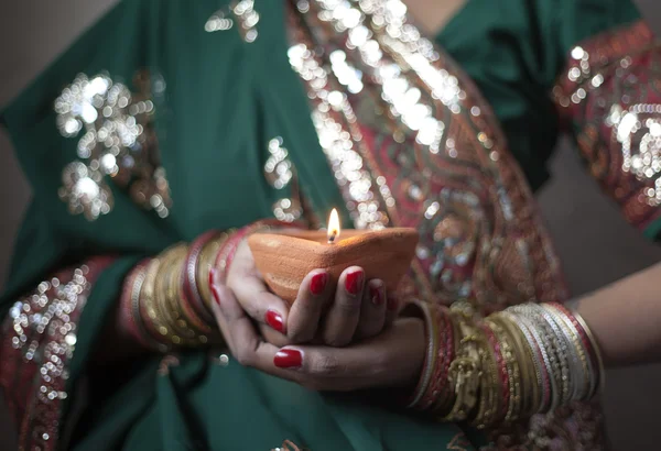 Young woman holding diwali lamp in hands — Stock Photo, Image