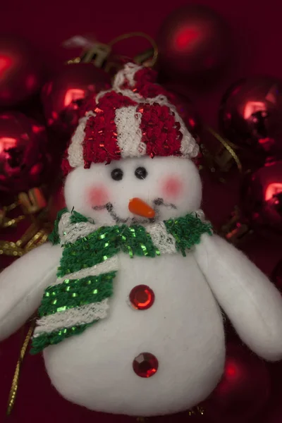 White snowman with red christmas ornaments — Stock Photo, Image