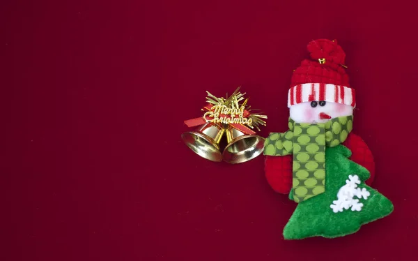 White and green snowman with gold merry christmas bells on red background — Stock Photo, Image