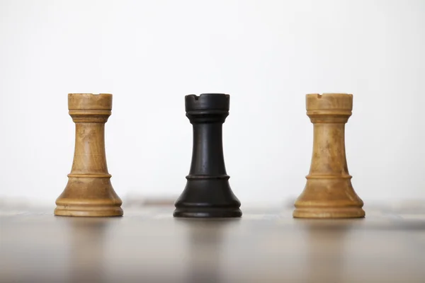 Wooden white and black rook chess pieces — Stock Photo, Image