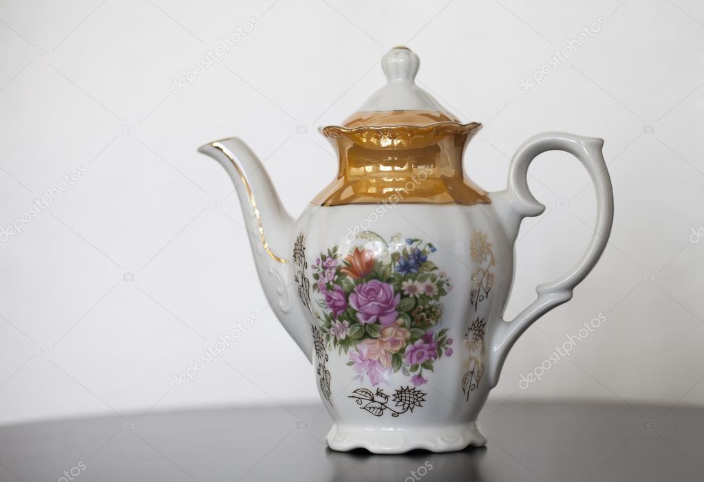 Antique porcelain teapot with flower print