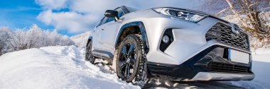Uzhhorod, Ukraine. January, 2021. Gray car of the Japanese brand Toyota RAV 4 hybrid. SUV, crossover. Reliable and beautiful car. Car in the winter mountains.	