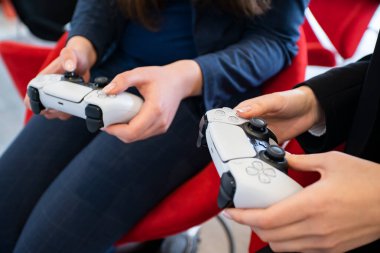 Uzhhorod. Ukrayna 16 Eylül 2021. Kızlar evlerinde PlayStation 5 oynuyorlar. Kablosuz Oyun Alanı. 