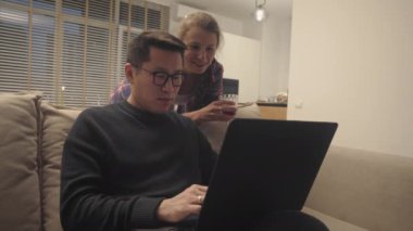 Cheerful diverse couple at home