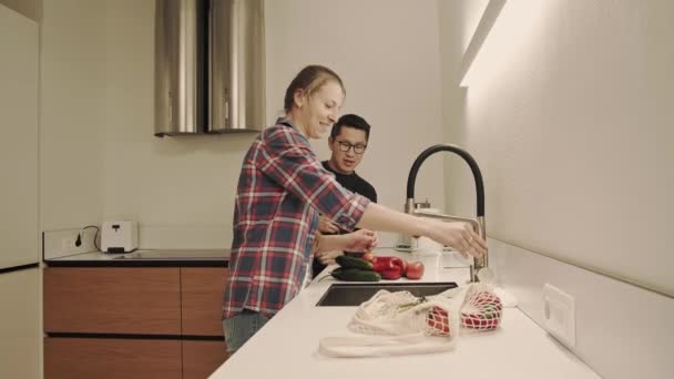 Man and woman cooking and drinks wine — Wideo stockowe