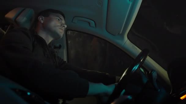 Мужчина водит машину ночью — стоковое видео