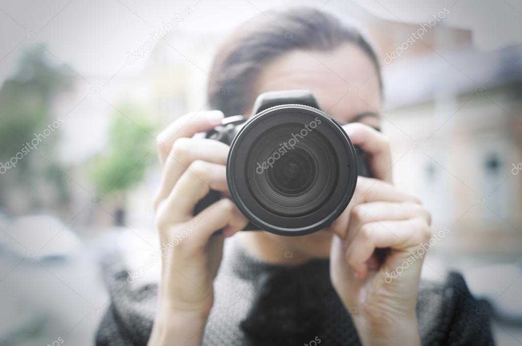 Young smiling girl making photo