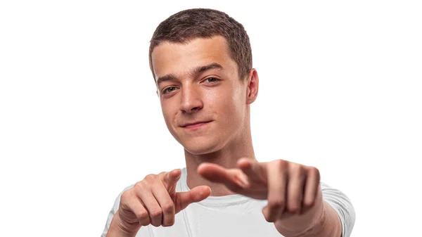 The young man points forward with his fingers. On a white background. — Stock Photo, Image