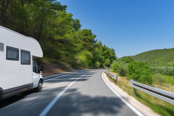 Camper trailer on Highway. road trip in motorhome