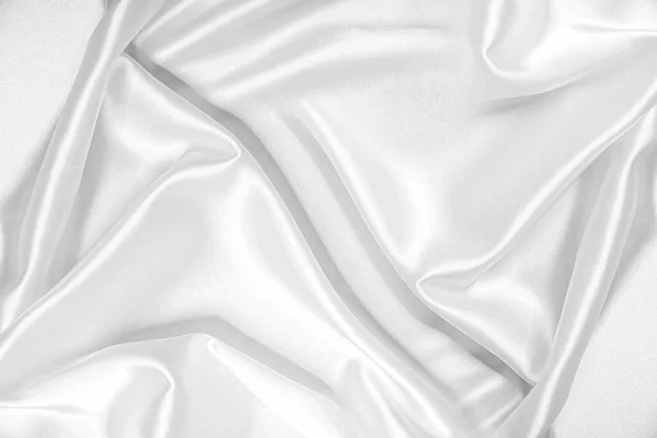 Close-up van golfde witte zijde stof. — Stockfoto