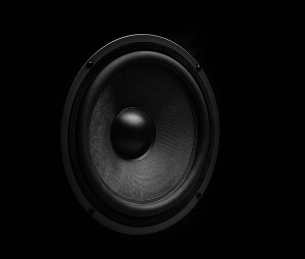 Beautiful powerful sound speaker close-up on a dark background.