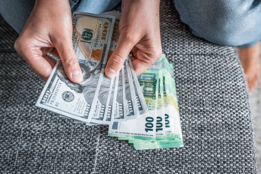 Euros and dollars in female hands. Dollar to euro exchange rate - concept.