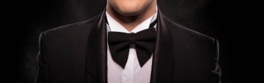Element of the image of a man dressed in a tuxedo on a dark background.