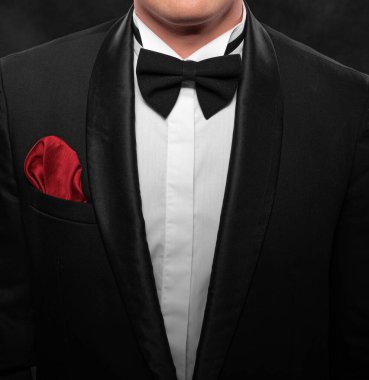 Element of the image of a man dressed in a tuxedo on a dark background.