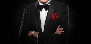 Element of the image of a man dressed in a tuxedo on a dark background.