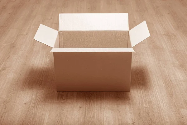 Postal cardboard box on a wooden background.