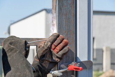 Work with a metal profile. A worker installs a metal profile.