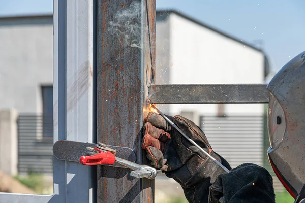 Work with a metal profile. A worker installs a metal profile.