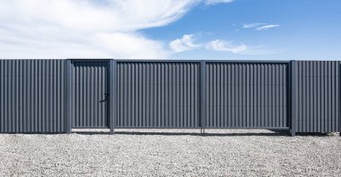 Iron gates from a profiled sheet on the site.