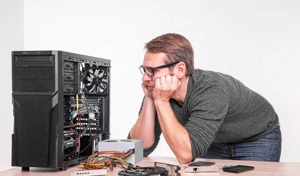 A specialist repairs a computer. Repair, assembly and restoration of personal computers.