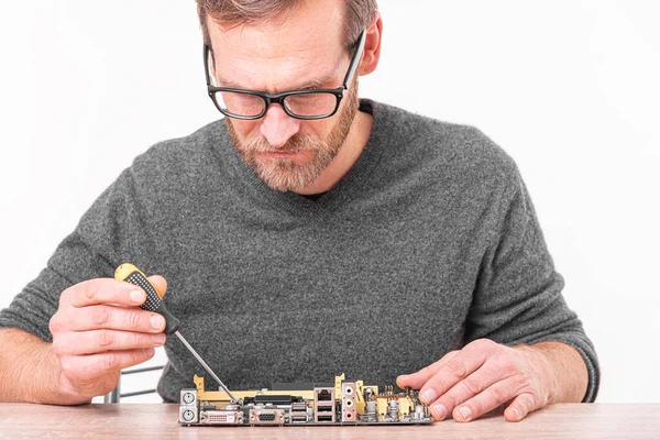 A specialist repairs a computer. Repair, assembly and restoration of personal computers.