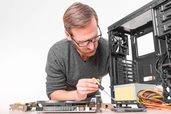 A specialist repairs a computer. Repair, assembly and restoration of personal computers.