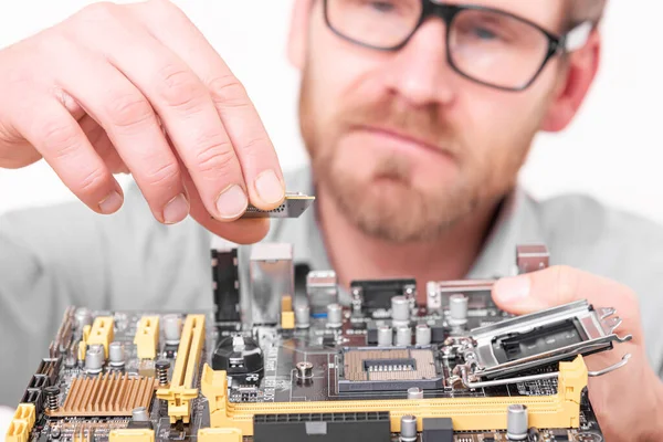 A specialist repairs a computer. Repair, assembly and restoration of personal computers.