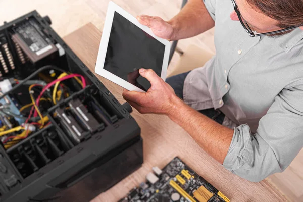 A specialist repairs a computer. Repair, assembly and restoration of personal computers.